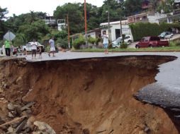 Varias personas observan los destrozos que ha dejado la tormenta tropical ‘‘Matthew’’ en Oaxaca. EFE  /