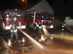 Bomberos limpian una calle cubierta con lodo tóxico procedente de una empresa de aluminio en Devecser, al suroeste de Budapest. EFE  /
