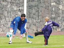 Corona trata de detener un balón a un niño aficionado de él y del Cruz Azul, durante la práctica. MEXSPORT  /