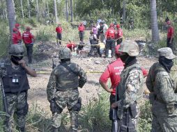 Durante la semana, agentes forenses y elementos militares participaron en el rescate de los cuerpos. AFP  /