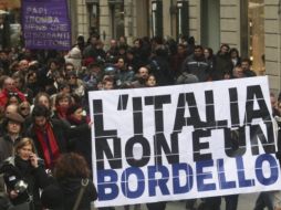 Manifestantes gritan consignas y muestran pancartas en las que se lee Italia no es un burdel. EFE  /