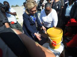 Hillary Clinton se lava las manos después de visitar un centro de tratamiento de enfermos de cólera, en Puerto Príncipe. AFP  /