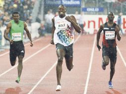 Usain Bolt (centro) ganó ayer la prueba de 200 metros bajo una pertinaz lluvia en Oslo. REUTERS  /