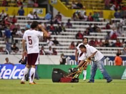 Los trabajadores del Estadio Jalisco limpian la 'marca' del equipo antes de iniciar el juego contra Estudiantes. EL INFORMADOR  /