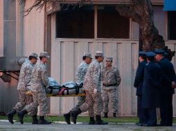 Miembros de la Fuerza Aérea chilena transportan uno de los cuatro cadáveres encontrados tras el accidente aéreo. AP  /