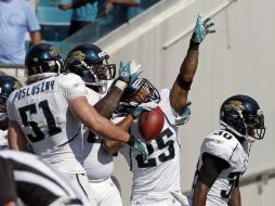 El defensa Dwight Lowery (25) celebra la intercepción de un pase con Paul Posluszny (51), Leger Douzable (2i). AP  /