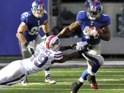 Ahmad Bradshaw (D) escapa lejos del jugador de los Bills Drayton Florence para concretar un touchdown. REUTERS  /