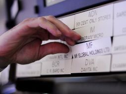 Un corredor de bolsa mueve un aviso de MF Global hoy, cuyos títulos se suspendieron en la Bolsa de Nueva York. EFE  /