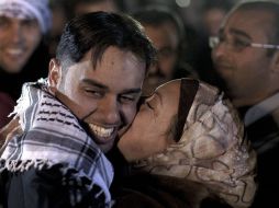 Un joven palestino recibe un besos de su madre después de ser liberado de una prisión israelí. EFE  /