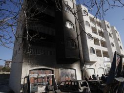 Palestinos se encuentran cerca de los coches que dicen los lugareños fueron incendiados por extremistas judíos. REUTERS  /