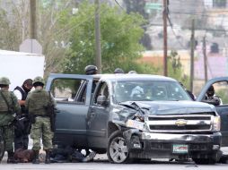 Miembros del Ejército y de la fiscalía estatal investigan a las afueras del estadio de Saltillo, donde se registró un tiroteo ayer. EFE  /