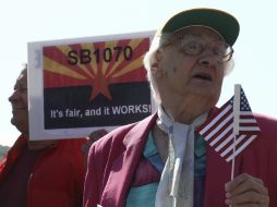 Manifestantes a favor de la SB 1070 sostienen pancartas afuera de la Suprema Corte. REUTERS  /