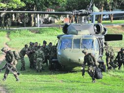Soldados colombianos transportan los cuerpos de siete guerrilleros de las FARC abatidos en bombardeo de la Fuerza Aérea Colombiana. EFE  /