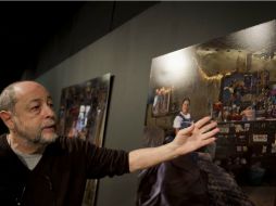El fotografo argentino Andy Goldstein mostrando la exhibición que documenta las condiciones de extrema pobreza en 14 países. AFP  /