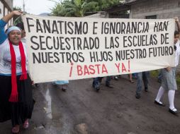 Habitantes protestan contra el grupo religioso que ha impedido el regreso a clases. AP  /