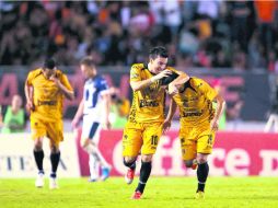 Édgar Andrade (derecha), quien fue el héroe de Jaguares al anotar dos goles, es felicitado por Jorge Marcelo Rodriguez. MEXSPORT  /