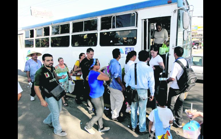 Tlajomulco de Zúiñga. Vecinos del fraccionamiento Santa Fe se agolpan en la puerta del camión para poder llegar a sus destinos.  /