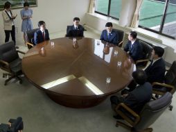 Delegados llegan a la reunión. AP /