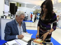 El escritor peruano firma un libro en el área de la feria. EFE /