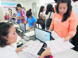 Para el camión. Jóvenes recogen Bienevales, otro de los programas de apoyo del Gobierno estatal para estudiantes.  /