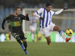 El delantero mexicano de la Real Sociedad, Carlos Vela (d), controla el balón junto a Rubén Pérez (i), del Elche. EFE /