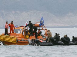Familiares de los pasajeros del ferry observan la labor de rescate. AP /