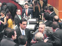 Cabildea. El coordinador de los diputados priistas, Manlio Fabio Beltrones, dialoga con un grupo de legisladores en el Senado. NTX /