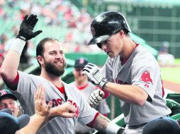 Encendido. Brock Holt (der.) es felicitado por Mike Napoli a su llegada a la caseta de Boston. AFP /