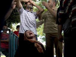 Las familias de los niños lloran sus muertes. AFP /