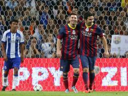 Deco es felicitado por Lionel Messi tras una anotación, mientras saca el balón de la portería  el portugués Paulo Ferreira. AFP /