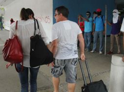 Turistas salen del aeropuerto de Acapulco durante la toma del edificio por maestros, normalistas y padres de familia, el pasado lunes. EFE / F. Meza