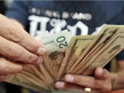 El Banco de México indicó que el tipo de cambio para pagar obligaciones en moneda extranjera pagaderas es de 14.7566 pesos. EL INFORMADOR / ARCHIVO