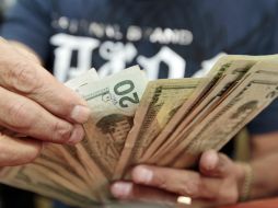 El Banxico fijó en 15.5645 pesos el tipo de cambio para solventar obligaciones en moneda extranjera. EL INFORMADOR / ARCHIVO