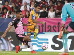 Javier Aquino saca su disparo, pese a la presión de Juan Carlos Valenzuela. EFE /