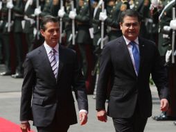 En punto de las 13:00 horas, los mandatarios escucharon himnos nacionales y saludaron a tropas en el Palacio Nacional. SUN / C. Mejía