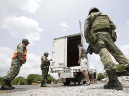 Las fuerzas federales mantienen retenes en varios puntos carreteros para inhibir actos de violencia. SUN / L. Cortés