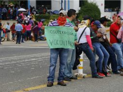 Además de la cooperación que solicitan, miembros de la CNTE distribuyen volantes sobre su lucha contra la reforma educativa. EFE / ARCHIVO