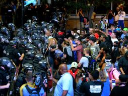 Los manifestantes ocasionaron cuantiosos destrozos a mobiliario urbano, comercios, viviendas y vehículos. AP / J. Siner