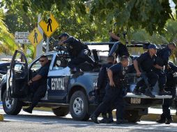 Policías durante la emergencia tras la agresión a varios edificios públicos en la zona Centro de Cancún. EFE / A. Cupul