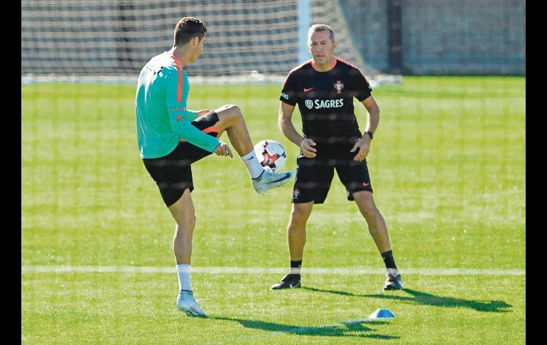 Por separado. Cristiano Ronaldo corrió y tocó algunos balones en compañía de un fisioterapeuta. AFP