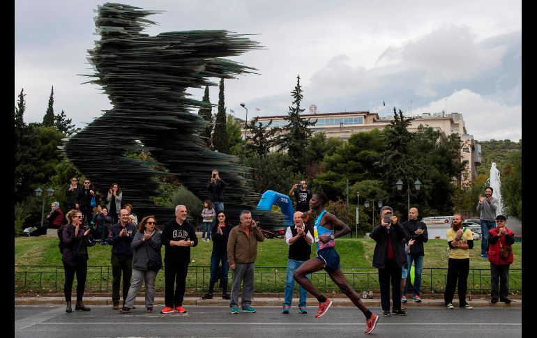 El keniano Samuel Kalalei (d) corre a la victoria frente a la estatua de cristal llamada 