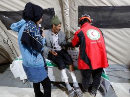 Un iraní herido por el terremoto recibe asistencia médica en un hospital temporal. EFE/A. Taherkenareh