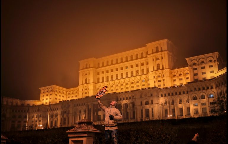 Una mujer sostiene un letrero que dice: 