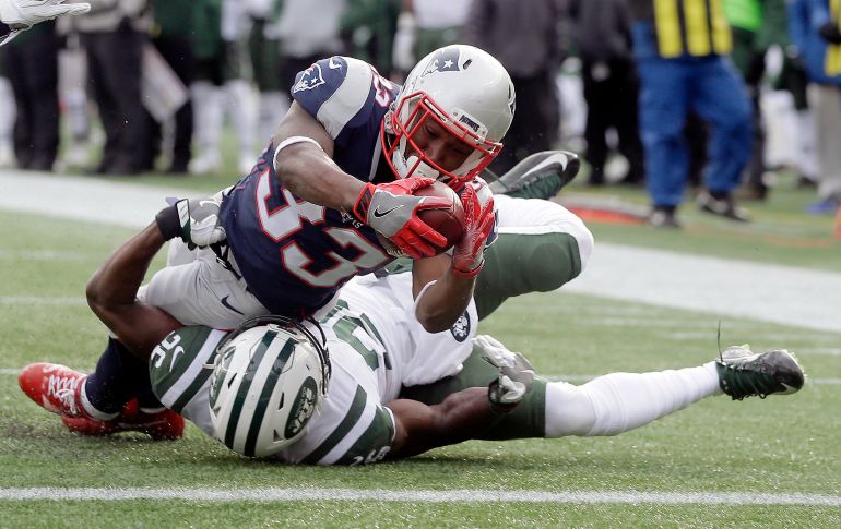 Dion Lewis (arriba), de los Patriotas de Nueva Inglaterra, va por un balón sobre Marcus Maye, de los Jets de Nueva York, y un touchdown en partido de la NFL en Foxborough, Estados Unidos. AP/S. Senne