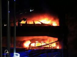 Vehicles burn during a blaze at a multi-storey car park at the Echo A - Vehicles burn during a blaze at a multi-storey car park at the Echo Arena on the waterfront in Liverpool, England Sunday, Dec. 31, 2017. An evening session of the Liverpool International Horse Show taking place in the Echo Arena was cancelled after horses were evacuated to safety. No one is known to have been injured in the fire. (Peter Byrne/PA via AP) Britain Fire - UNITED KINGDOM OUT  NO SALES  NO ARCHIVE  PHOTOGRAPH CANNOT BE STORED OR USED FOR MORE THAN 14 DAYS AFTER THE DAY OF TRANSMISSION