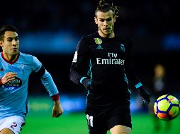 El doblete de Bale (D) apenas les alcanza a los merengues para negociar la repartición de puntos. AFP/M. RIopa