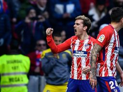 El francés Antoine Griezmann (I) celebra tras abrir el marcador para los Colchoneros. AFP/O. del Pozo