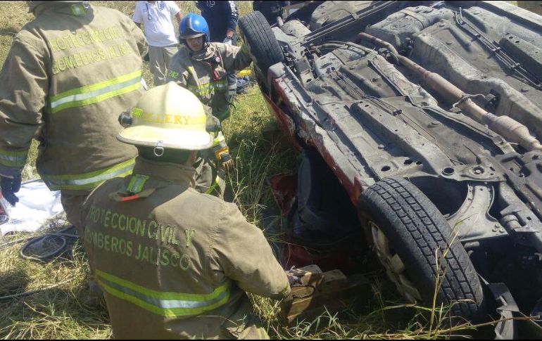 Bomberos municipales y del estado trabajaron en conjunto para liberar a las dos personas heridas que se encontraban atrapadas en el auto. ESPECIAL/UEPCBJ
