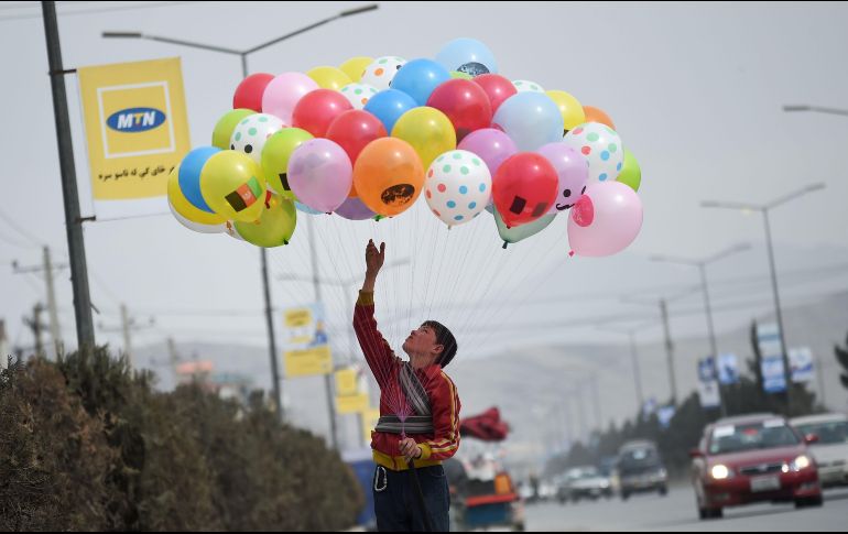 Un niño vende globos en una calle de Kabul, Afganistán. AFP/W. Kohsar