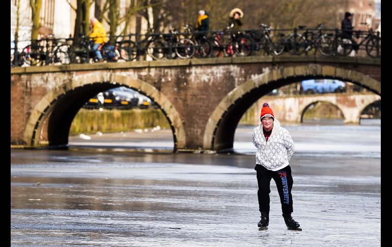 Un hombre patina sobre el canal  Keizersgracht de Ámsterdam, en Holanda.